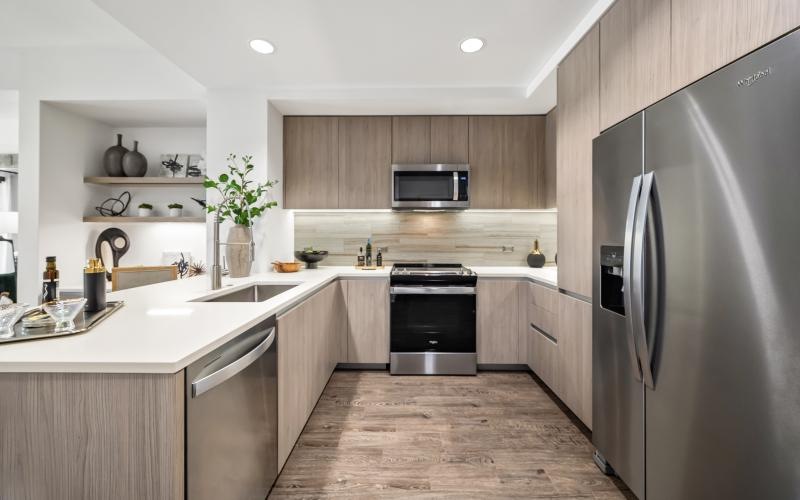 a kitchen with a stainless steel refrigerator